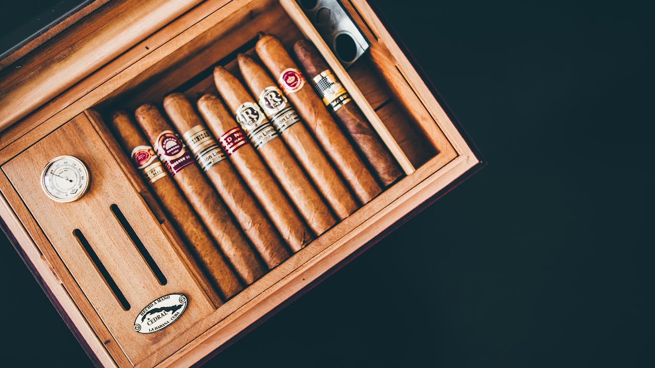 our-story-01 Close-up of premium Cuban cigars in a wooden humidor box, showcasing luxury and craftsmanship.